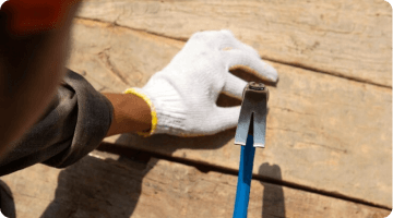 person hammering a nail